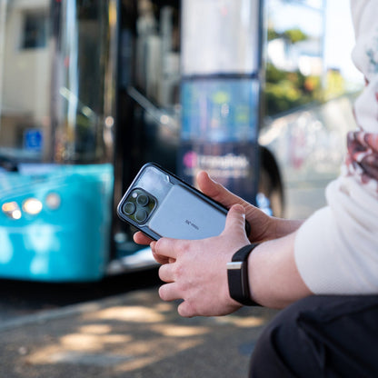 Ultra slim power bank in a persons hand waiting for bus